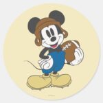 Sporty Mickey Holding Football Classic Round Sticker