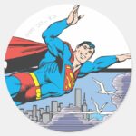 Superman Flies Thru City Classic Round Sticker